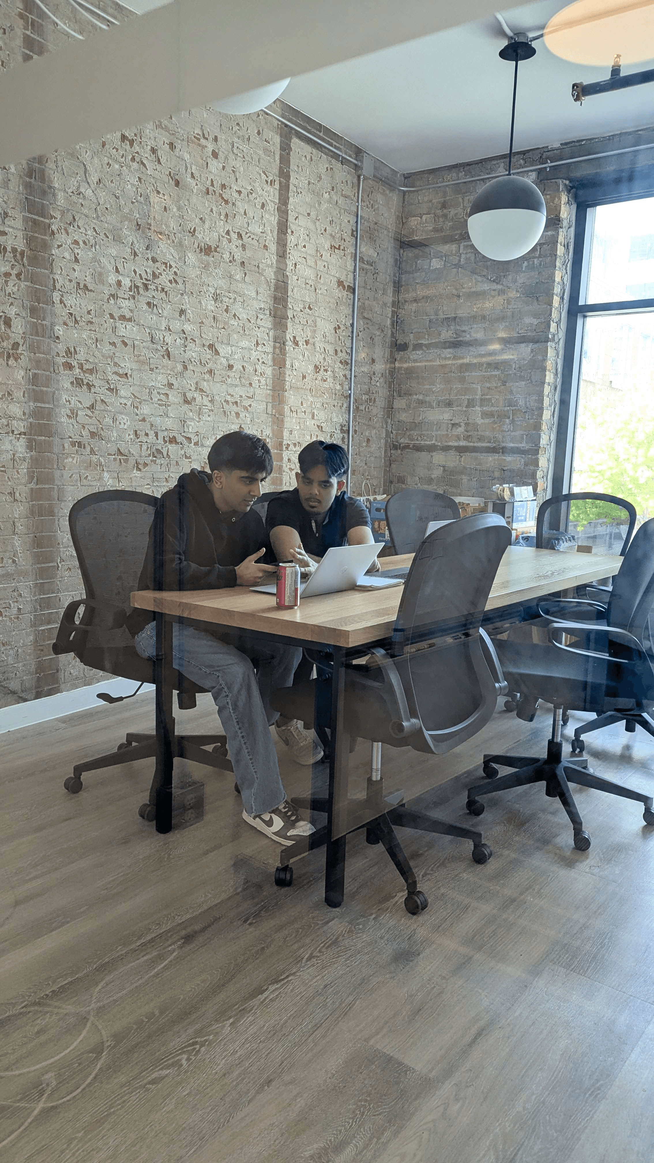 Clearline teammates collaborating at a laptop
