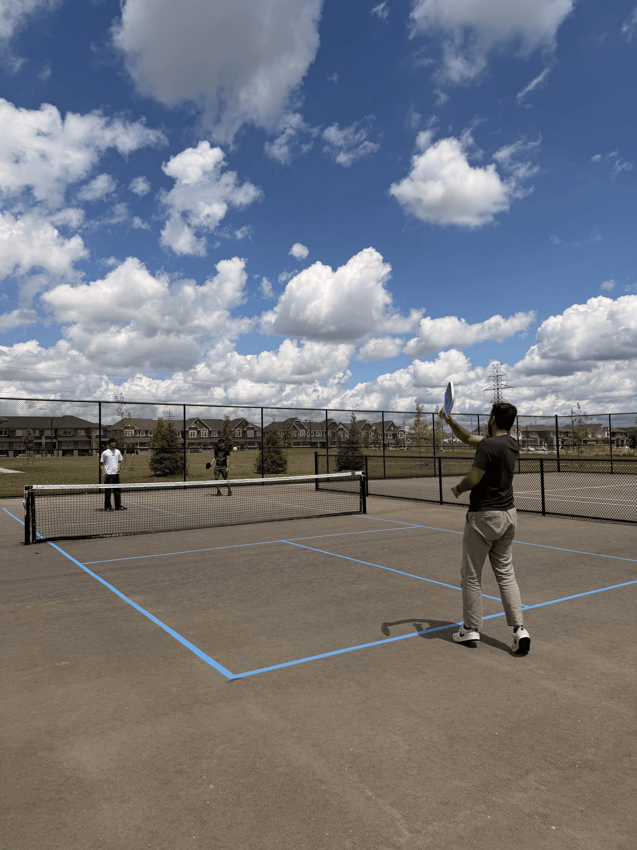 Clearline team playing pickleball outdoors