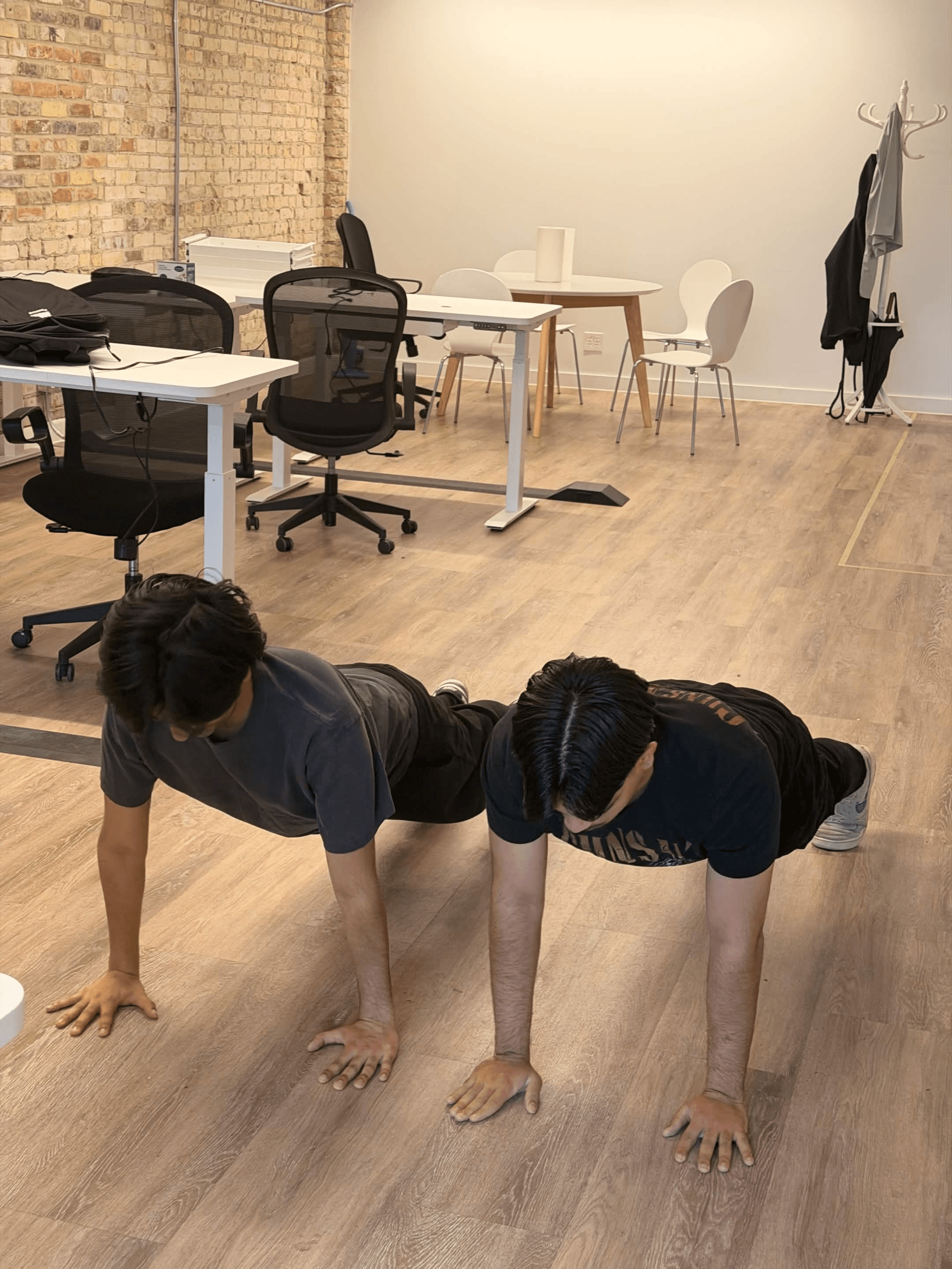 Clearline teammates taking a push-up break in the office