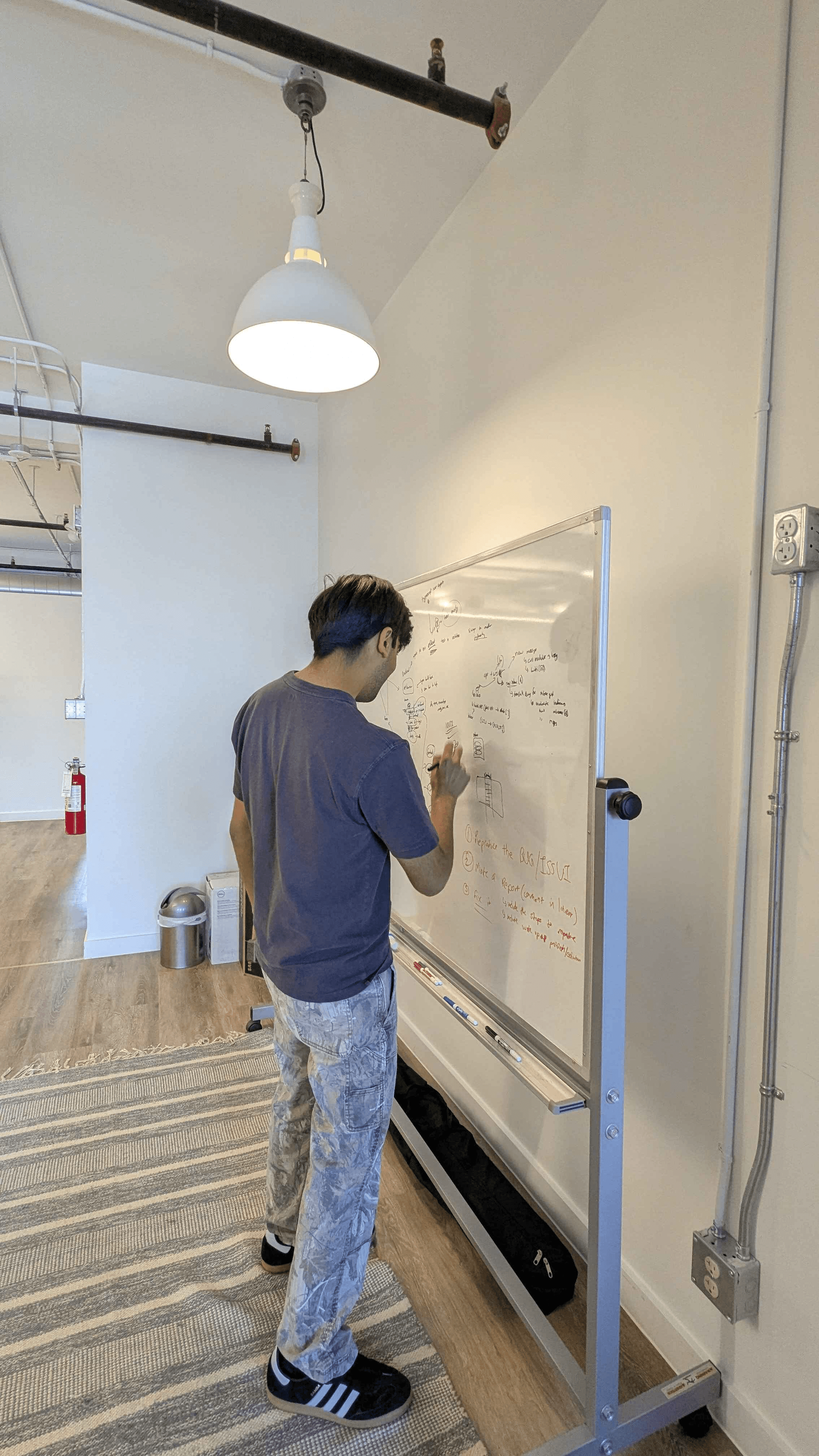 Clearline teammate working through an idea at the whiteboard